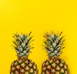 Summer concept. Conceptual. Tasty appetizing half of pineapple on yellow bright vibrant background. Flat Lay.