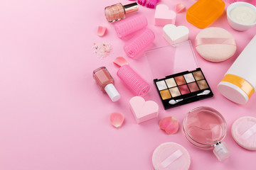 Beauty Spa Feminine Concept. Different Make Up Beauty Care Essentials Cosmetics on Flat Lay Pink Background. Top View. Side Composition.
