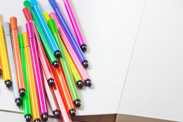 Obraz premium Multicolored markers lie on paper. Drawing. Writing goods 