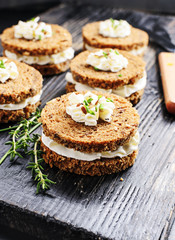Sandwiches rye bread with cream cheese and mix seeds on a beige marble table  . Health snacks concept. Top view. Copy space.