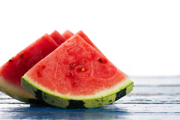 Sliced watermelon Side Composition. Many slices on an old rustic blue table. Copy space. Food Backgound.