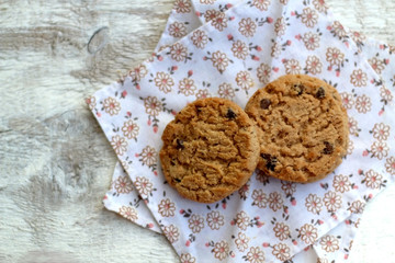 Chocolate chip cookies on a floral napkin. Top view. 