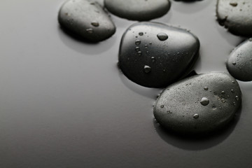 Beautiful picture of Spa Hot Stones, View from Above. Dark Background. Top. Spa Concept. Side Composition.