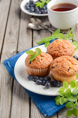 Homemade  blueberry muffins on rustic wooden background, selective focus