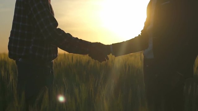 Businessman and farmer shake their hands slow motion