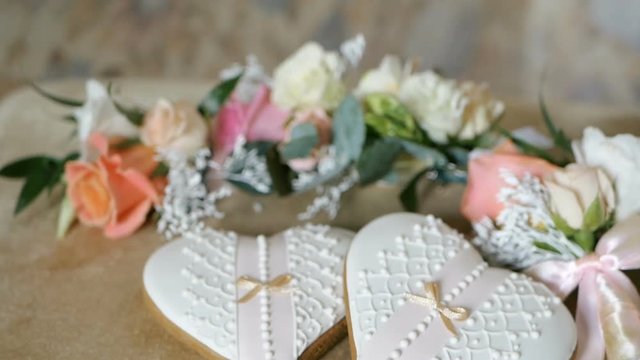 Cookies in the form of hearts. Wedding inscriptions, boutonnieres flowers