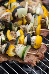 barbecue with delicious grilled meat and vegetable on grill