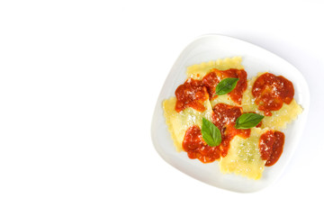 Ravioli with tomato sauce and basil isolated on white background
