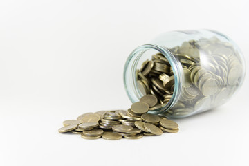 Money in a glass jar on a white background