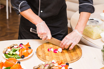 Close-up of chef cooking food kitchen restaurant cutting cook hands hotel man male knife preparation fresh preparing concept
