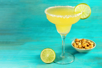 Margarita cocktail on blue background with copyspace