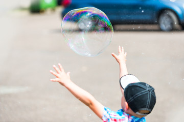 Kid Catching Bubble. Family Spending Free Time In The Park. 