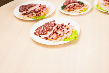 Dish with sliced meat products on the festive table