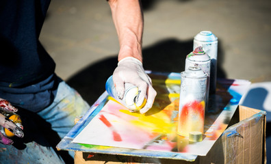 Artist Holding a Spray Paint And Drawing on Paper