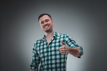 Portrait of man on gray background. Man showing different emotions.