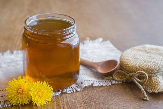 Dandelions honey syrup in the glass jar made in springtime. Homemade sweet food.