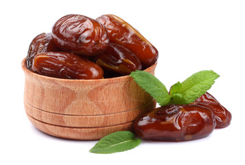 date fruit in wooden bowl isolated on white background