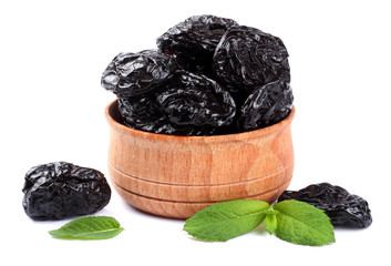 Dried plums - prunes in wooden bowl isolated on white background