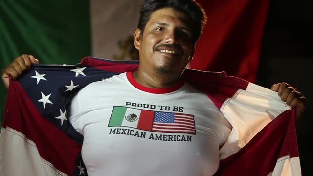 Man rips open USA jacket to Mexican American shirt, close up