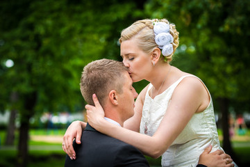 The bride and groom in nature. The love story of the newlyweds in the park.