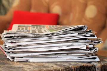 Newspapers on wooden table