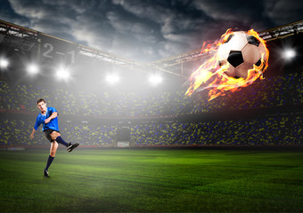 Obraz na płótnie Canvas soccer or football player is kicking ball on stadium