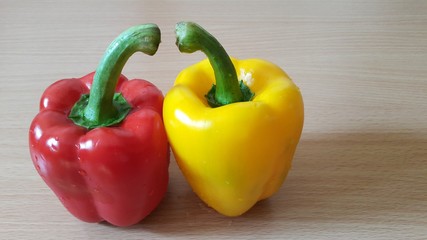 Bell peppers, isolated on the wooden table.
