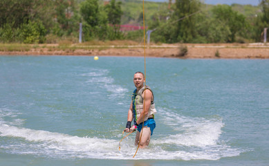 Man study wakeboarding on a blue lake