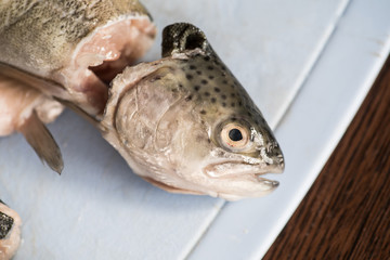 Rainbow trout with head cut off before cooking