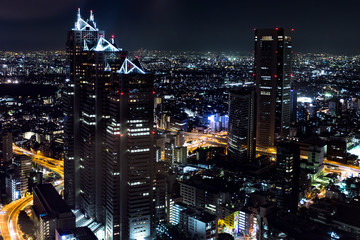 View to Tokyo city panorama from above at night showing car lights and illumination