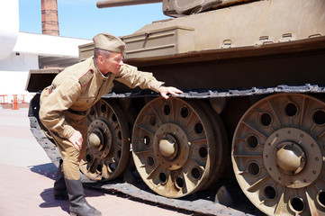 Soldier of Red Army in the form of times of World War II at the T-34 tank