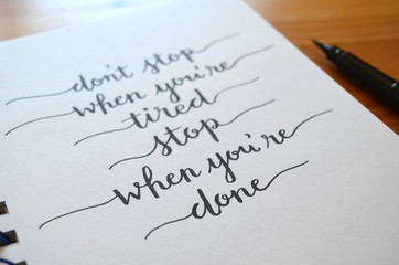 DON’T STOP WHEN YOU’RE TIRED STOP WHEN YOU’RE DONE hand lettered in notepad © HowLettery Studio