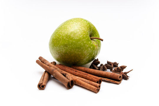 A Green Apple, Cinnamon Sticks And Star Anise Isolated On A White Background