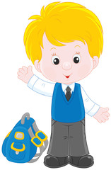 Little schoolboy smiling, standing with his schoolbag and waving in greeting