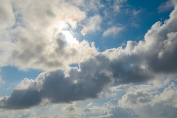 Dark,swirling clouds in the blue sky.