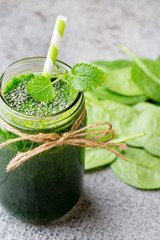 Spinach smoothie, on the grey  background.