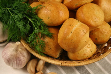Homemade buns with garlic and dill on wooden table. Selective focus.