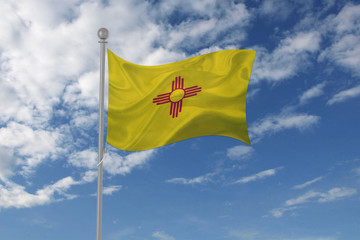 New Mexico flag waving in the sky