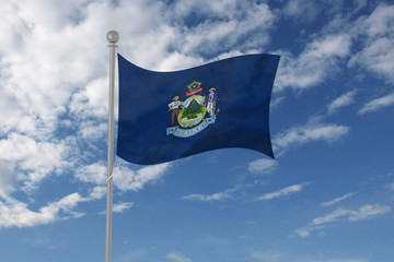 Maine flag waving in the sky