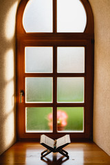 Quran in front of amazing wooden window