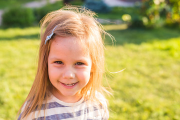 Portrait of sweet little girl play outdoors