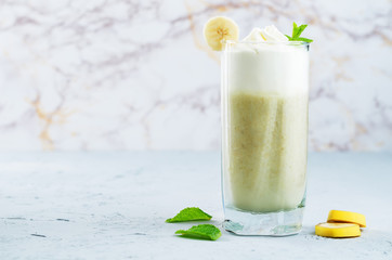 Banana milkshake with cream, fresh banana and mint
