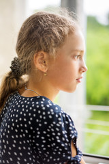 Portrait of young girl near the window