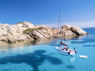 Aerial view of a sail boat in front of Mortorio island in Sardinia. Amazing beach with a turquoise...