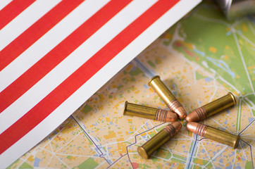 Fototapeta na wymiar Close up of five bullets with a United States flag on a map, on wooden table