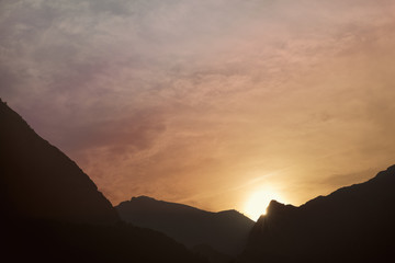 Silhouettes of the mountain hills at sunset. mountain cascade