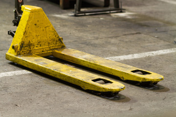 yellow pallet lifter, pallet truck in factory