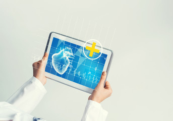 Close of female doctor hands working with tablet pc computer