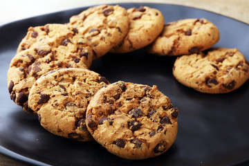 Chocolate cookies on wooden table. Chocolate chip cookies shot