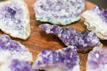 Crystals of amethyst on a wooden plate.